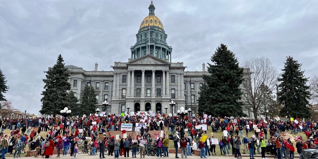 Colorado state capitol with protesters outside