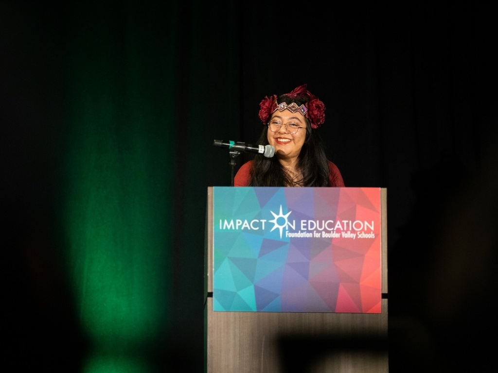 Cecilia Chigo smiling at podium
