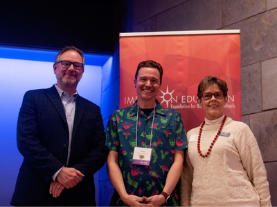 Educator award winner smiling with BVSD superintendent and board member