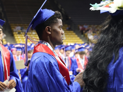 Addisu in cap and gown at graduation