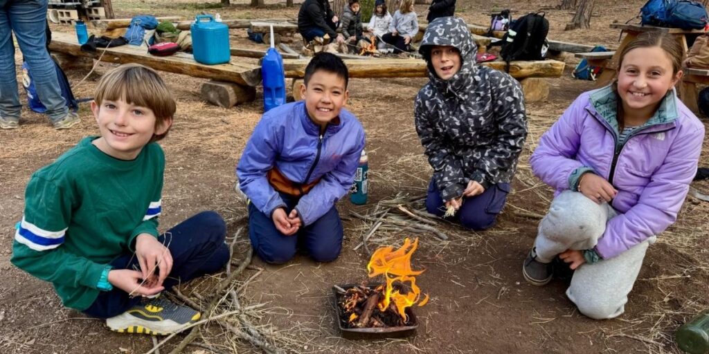 Students sitting around a campfire